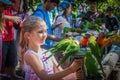 Brisbane Australia Little girl with pink printed dress hold feeder with lorikeets perched eating from it Royalty Free Stock Photo